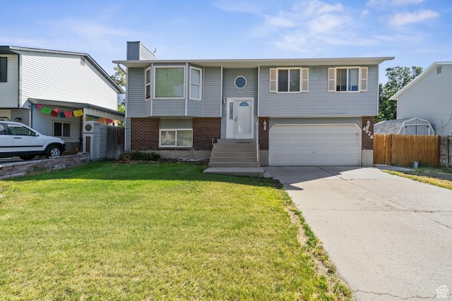 4924 W Barton Park Dr, West Jordan, UT 84081 - raised ranch featuring brick siding, an attached garage, driveway, and a chimney