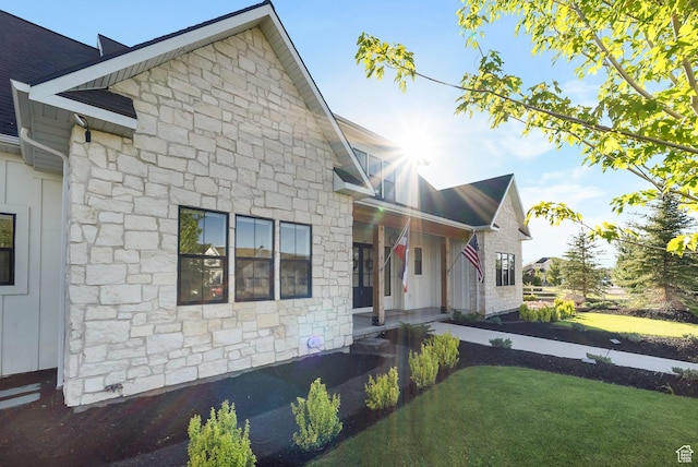 1474 E Rock View Ct, Kamas, UT 84036 - view of front facade featuring stone siding, a front lawn, and covered porch