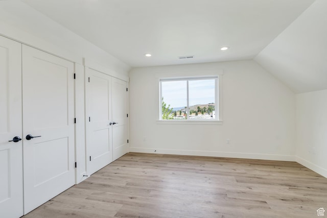 1474 E Rock View Ct, Kamas, UT 84036 - unfurnished bedroom featuring two closets, light wood-style floors, recessed lighting, baseboards, and vaulted ceiling