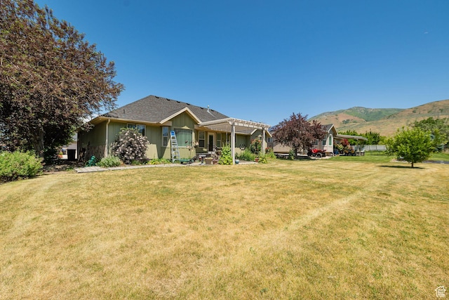 1257 W 3275 S, Perry, UT 84302 - view of front facade with a pergola, board and batten siding, a front lawn, and a mountain view