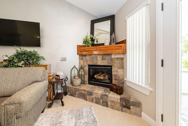 1257 W 3275 S, Perry, UT 84302 - carpeted living area featuring a stone fireplace, plenty of natural light, and baseboards