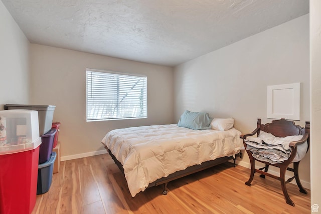 8567 S Cork Oak Dr, West Jordan, UT 84081 - bedroom with light wood-type flooring, baseboards, and a textured ceiling