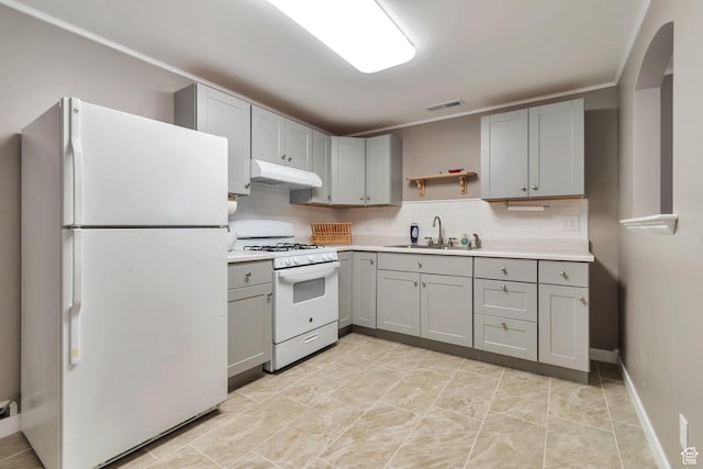 8567 S Cork Oak Dr, West Jordan, UT 84081 - kitchen with white appliances, a sink, gray cabinets, under cabinet range hood, and light countertops