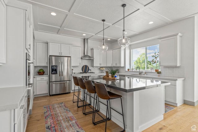 6653 W Dry Creek Ln, Highland, UT 84003 - kitchen featuring stainless steel refrigerator with ice dispenser, coffered ceiling, wall chimney exhaust hood, a sink, and a center island
