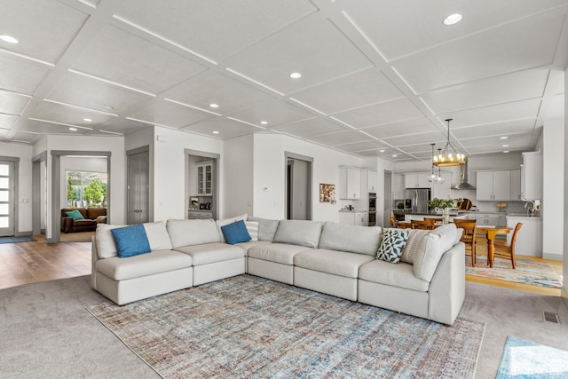 6653 W Dry Creek Ln, Highland, UT 84003 - living room with light colored carpet, coffered ceiling, recessed lighting, and a chandelier