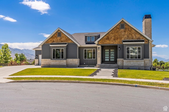 6653 W Dry Creek Ln, Highland, UT 84003 - craftsman inspired home with french doors, a front yard, a chimney, and a mountain view