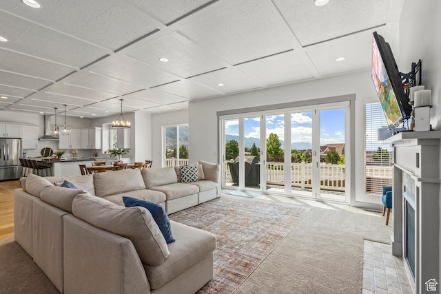 6653 W Dry Creek Ln, Highland, UT 84003 - living room featuring recessed lighting, a fireplace, coffered ceiling, light colored carpet, and a chandelier