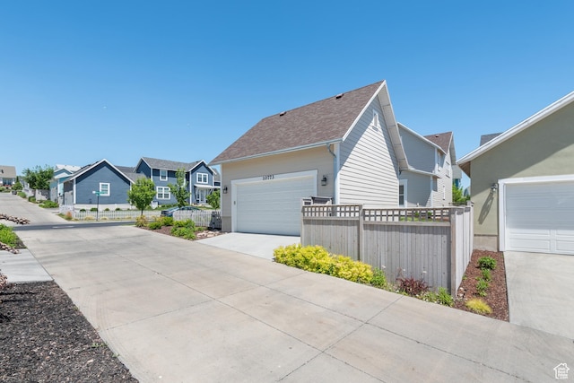 10773 S Beach Comber Way S, Jordan, UT 84009 - view of home's exterior featuring a residential view, concrete driveway, and roof with shingles