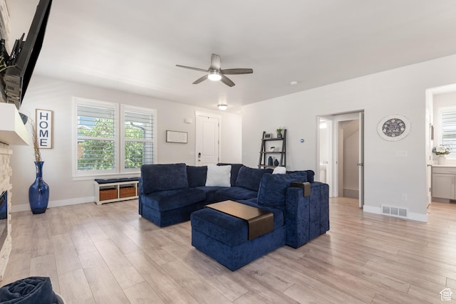 10773 S Beach Comber Way S, Jordan, UT 84009 - living area featuring ceiling fan, light wood-style floors, and baseboards