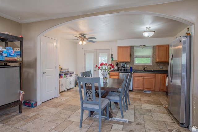 3746 S 7200 W, Magna, UT 84044 - dining room with stone tile floors, arched walkways, and a ceiling fan