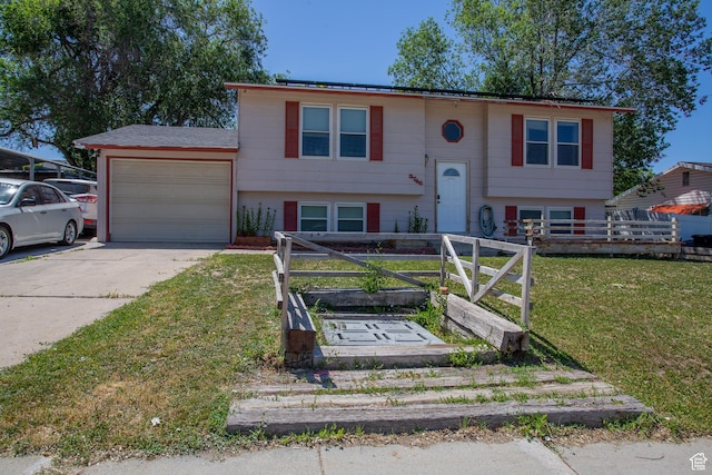 3746 S 7200 W, Magna, UT 84044 - bi-level home with a garage, concrete driveway, and a front yard