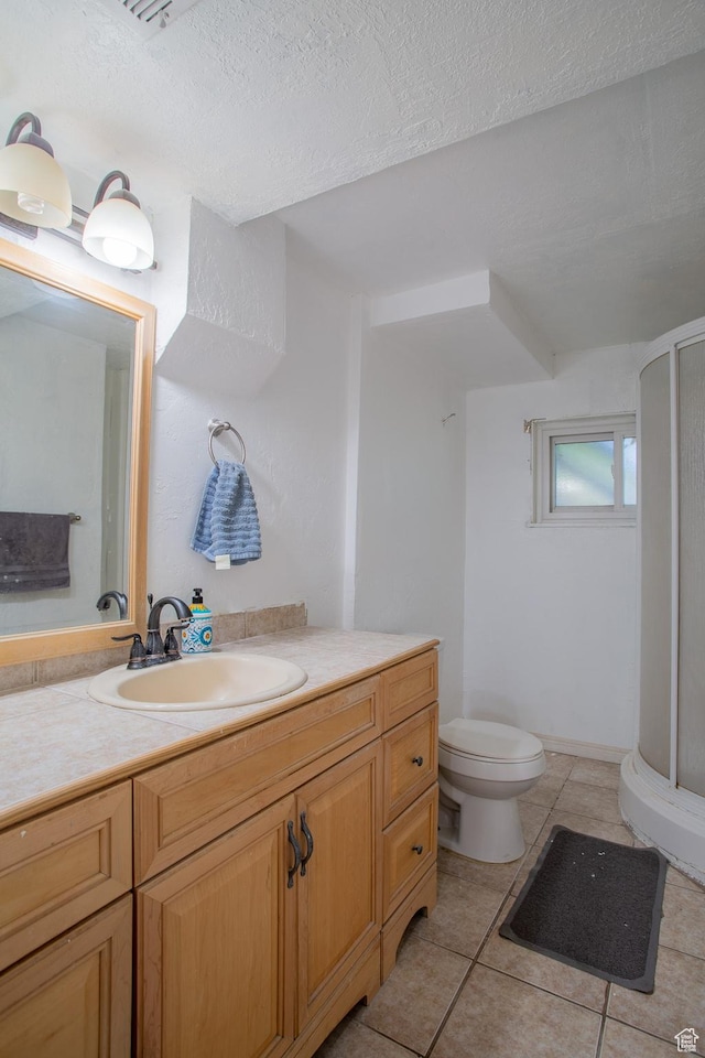 3746 S 7200 W, Magna, UT 84044 - bathroom with a stall shower, toilet, vanity, tile patterned flooring, and a textured ceiling