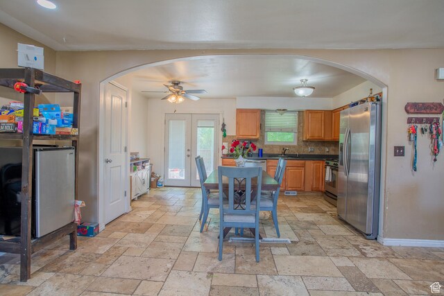 3746 S 7200 W, Magna, UT 84044 - kitchen featuring appliances with stainless steel finishes, arched walkways, stone tile flooring, a sink, and dark countertops