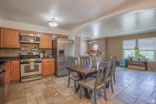 3746 S 7200 W, Magna, UT 84044 - kitchen featuring stainless steel appliances, stone tile flooring, ceiling fan, and dark countertops