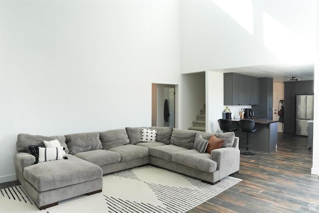 1204 Hyperion Way, Soda Springs, ID 83276 - living area featuring dark wood finished floors, stairway, a towering ceiling, and baseboards