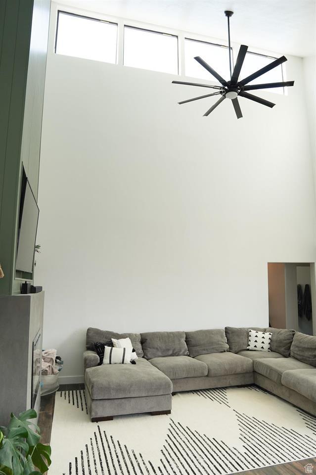 1204 Hyperion Way, Soda Springs, ID 83276 - living room featuring a towering ceiling, a ceiling fan, and baseboards
