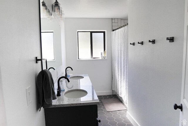 1204 Hyperion Way, Soda Springs, ID 83276 - full bath featuring double vanity, baseboards, tile patterned floors, and curtained shower