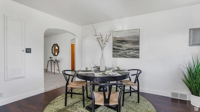 23 W Cottage Ave, Sandy, UT 84070 - dining space featuring arched walkways, baseboards, and wood finished floors
