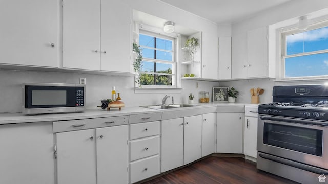 23 W Cottage Ave, Sandy, UT 84070 - kitchen featuring appliances with stainless steel finishes, a sink, light countertops, and white cabinetry