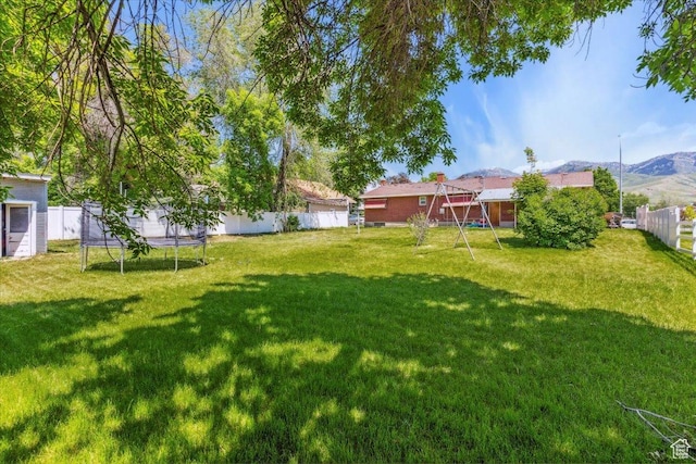 339 S Main St, Smithfield, UT 84335 - view of yard featuring a trampoline and a mountain view