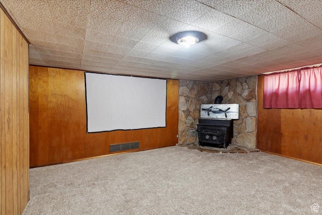 339 S Main St, Smithfield, UT 84335 - carpeted cinema room featuring a wood stove and wooden walls