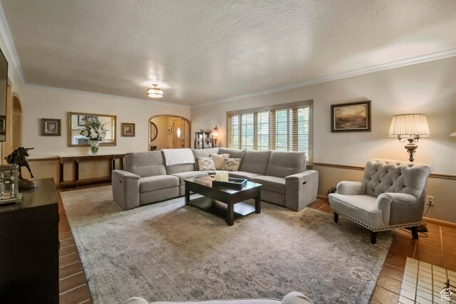 1377 E Wilson Ave, Salt Lake City, UT 84105 - tiled living room with arched walkways, crown molding, baseboards, and a textured ceiling