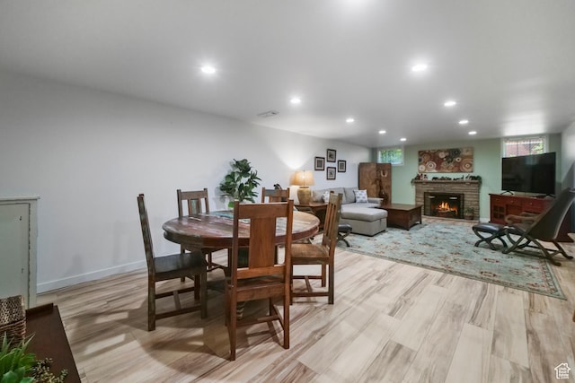 1377 E Wilson Ave, Salt Lake City, UT 84105 - dining area featuring a fireplace, light wood-style floors, and recessed lighting