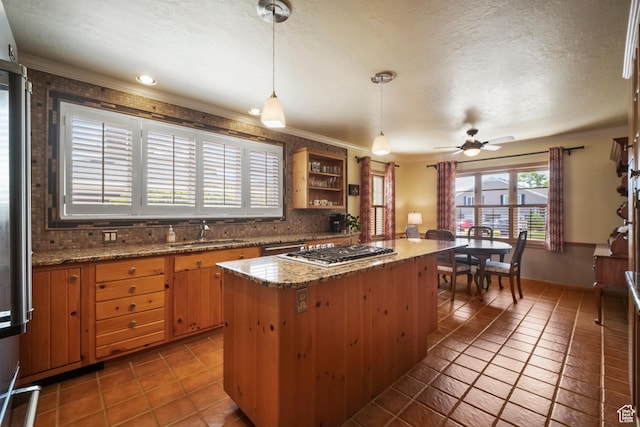 1377 E Wilson Ave, Salt Lake City, UT 84105 - kitchen featuring a sink, tile patterned flooring, decorative backsplash, a center island, and ornamental molding
