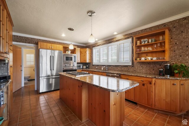 1377 E Wilson Ave, Salt Lake City, UT 84105 - kitchen with appliances with stainless steel finishes, a sink, tasteful backsplash, ornamental molding, and dark tile patterned floors
