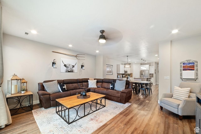 5048 N Escapes Dr, St George, UT 84770 - living area with light wood finished floors, a ceiling fan, recessed lighting, and baseboards