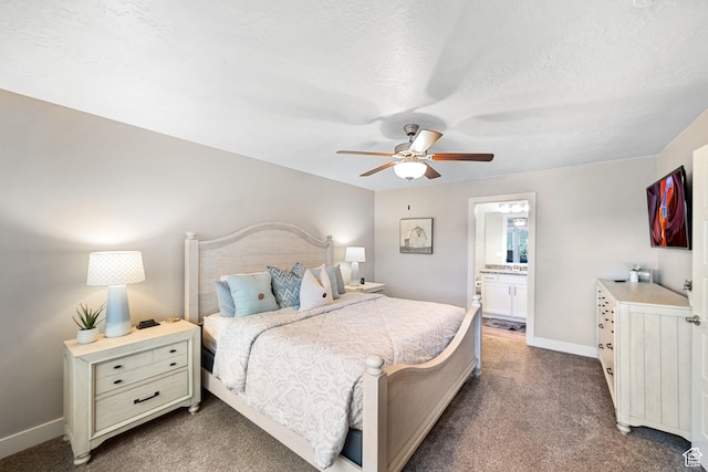 5048 N Escapes Dr, St George, UT 84770 - bedroom featuring dark colored carpet, baseboards, a ceiling fan, and connected bathroom