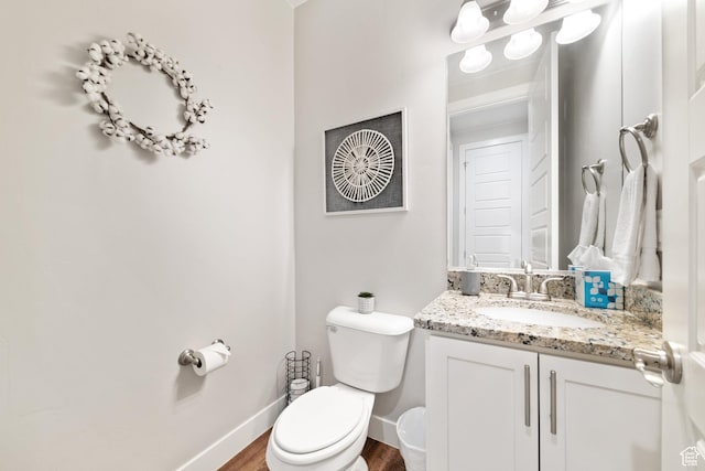 5048 N Escapes Dr, St George, UT 84770 - bathroom featuring toilet, vanity, wood finished floors, and baseboards