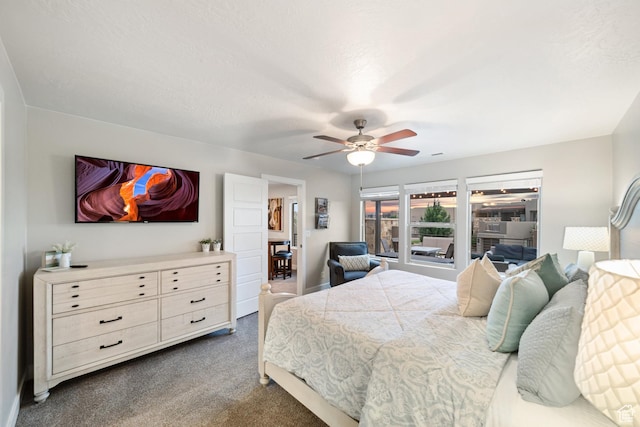 5048 N Escapes Dr, St George, UT 84770 - bedroom with dark colored carpet and a ceiling fan