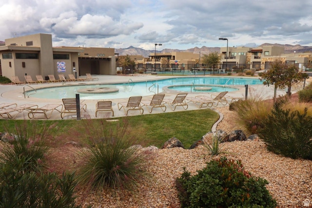 5048 N Escapes Dr, St George, UT 84770 - community pool with a residential view, a hot tub, a patio, and a mountain view