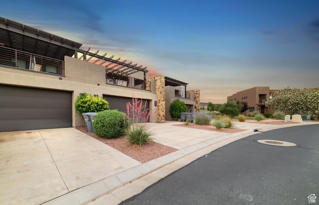 5048 N Escapes Dr, St George, UT 84770 - modern home with stucco siding, driveway, and a garage