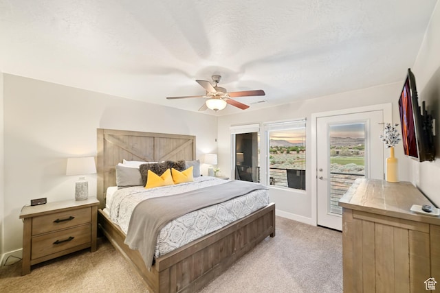 5048 N Escapes Dr, St George, UT 84770 - bedroom featuring access to outside, light colored carpet, baseboards, and a ceiling fan