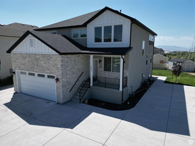 1573 N Woodside Dr, Spanish Fork, UT 84660 - view of front of property with stone siding, covered porch, driveway, and board and batten siding