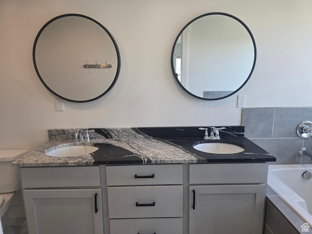 1573 N Woodside Dr, Spanish Fork, UT 84660 - full bathroom with double vanity, a relaxing tiled tub, and toilet