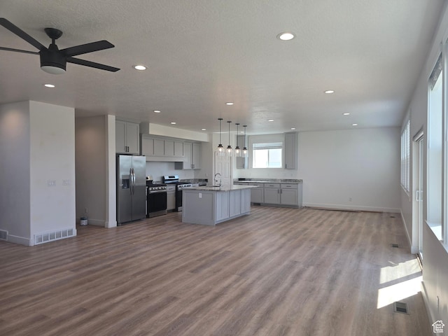 1573 N Woodside Dr, Spanish Fork, UT 84660 - kitchen featuring stainless steel appliances, open floor plan, gray cabinetry, a sink, and a ceiling fan
