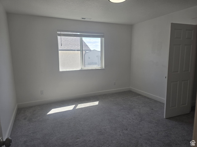 1573 N Woodside Dr, Spanish Fork, UT 84660 - spare room featuring dark carpet, baseboards, and a textured ceiling