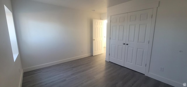 1573 N Woodside Dr, Spanish Fork, UT 84660 - unfurnished bedroom with a closet, dark wood finished floors, and baseboards