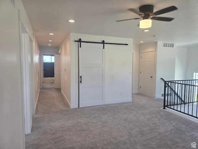 1573 N Woodside Dr, Spanish Fork, UT 84660 - corridor featuring carpet floors, a barn door, baseboards, recessed lighting, and a textured ceiling