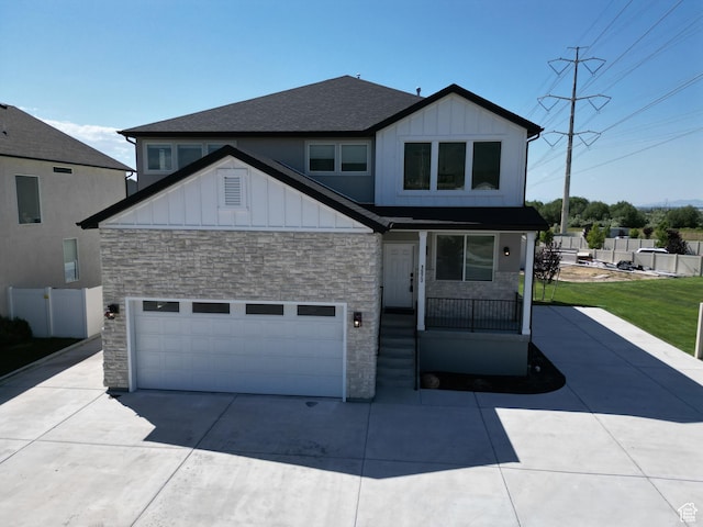 1573 N Woodside Dr, Spanish Fork, UT 84660 - view of front facade featuring board and batten siding, stone siding, and driveway