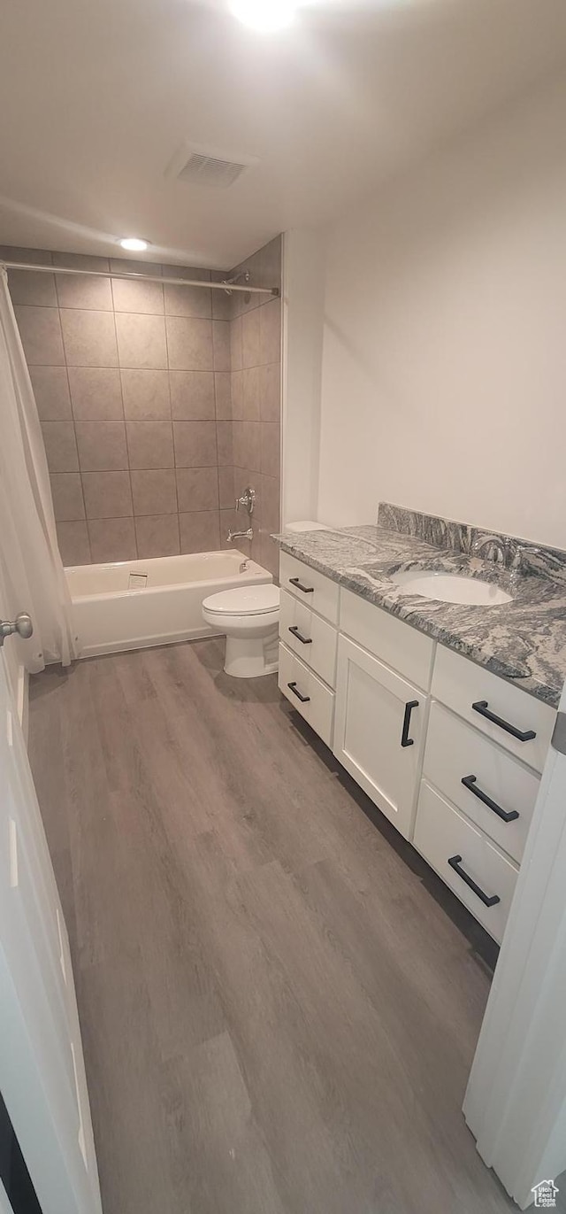 1573 N Woodside Dr, Spanish Fork, UT 84660 - full bath with vanity, wood finished floors, shower / bath combo, and toilet
