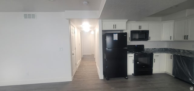 1573 N Woodside Dr, Spanish Fork, UT 84660 - kitchen with black appliances, dark wood-style floors, baseboards, white cabinetry, and dark countertops
