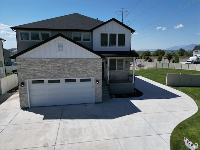 1573 N Woodside Dr, Spanish Fork, UT 84660 - view of front of home with stone siding, board and batten siding, a shingled roof, and concrete driveway