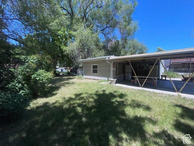 4562 S 785 E, Millcreek, UT 84107 - rear view of house with a yard