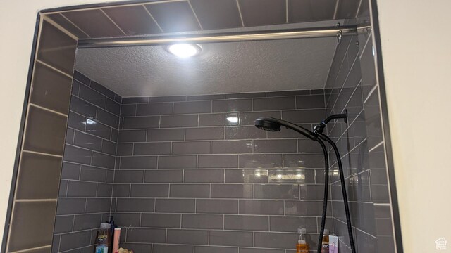 3065 S Brinker Ave, Ogden, UT 84403 - bathroom view of tiled shower and a textured ceiling