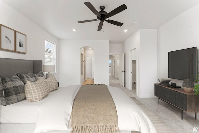6134 S Kelly Ln, St George, UT 84790 - bedroom featuring arched walkways, light colored carpet, recessed lighting, a ceiling fan, and baseboards