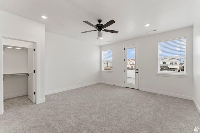 6134 S Kelly Ln, St George, UT 84790 - unfurnished bedroom featuring light colored carpet, multiple windows, a spacious closet, and recessed lighting